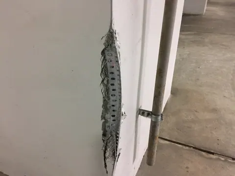 下地が露出するほど角が欠けた壁の補修前
