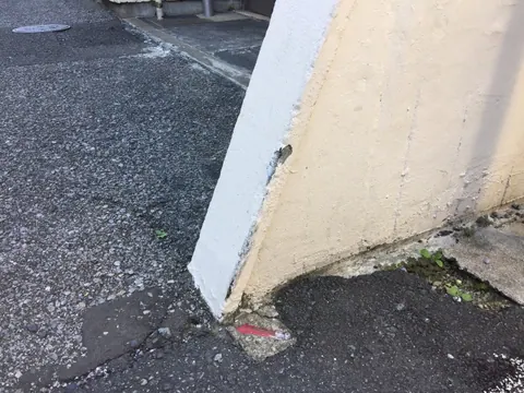 下部の角に欠けが見られる塀の補修前